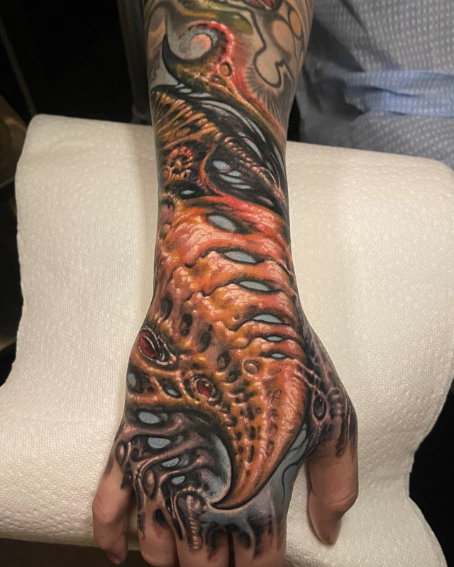 Color forearm and hand tattoo of dragon wing by Shaine Smith of Sacred Mandala Studio.