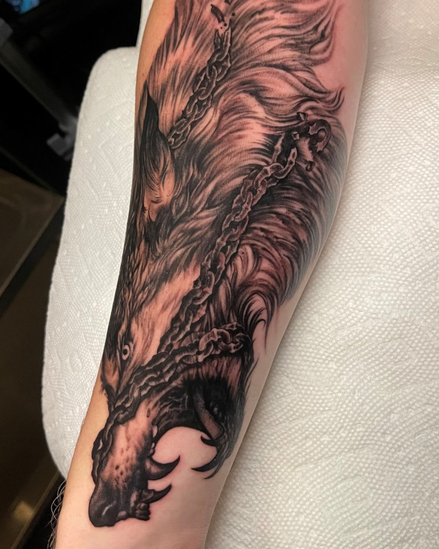 Tattoo of the norse myth of Fenir the Wolf done in black and grey fine line ink by Shaine Smith of Sacred Mandala Studio.