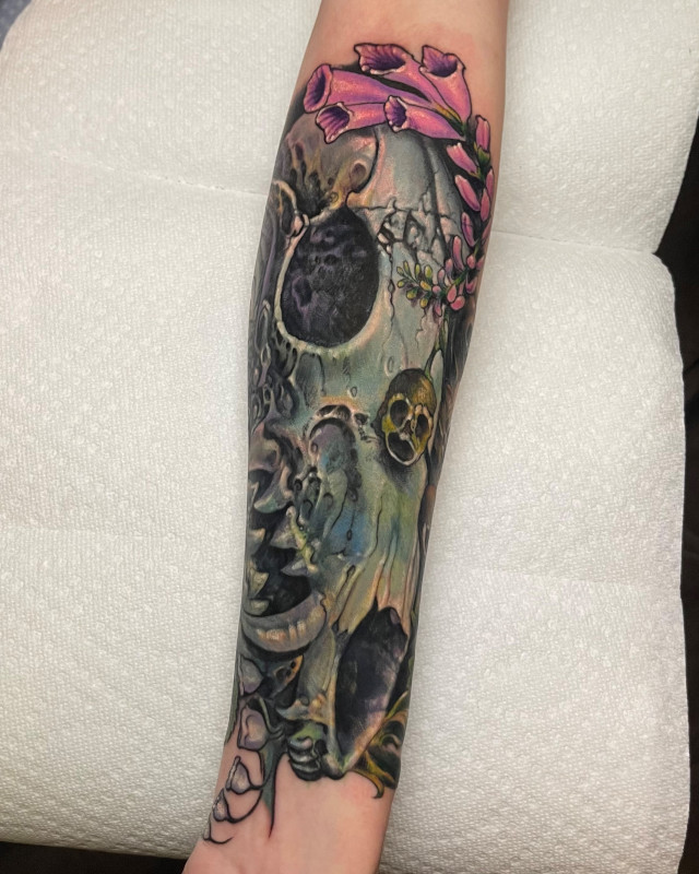 Color tattoo of water horse skull with flowers surrounding by Shaine Smith of Sacred Mandala Studio.