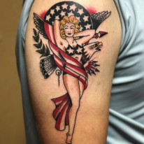 Classic American Pinup girl tattoo done in color with an eagle in the background by Tattoo Artist Jerry Martin II of Sacred Mandala Studio - tattoo studio and art gallery in the Triangle, NC (Durham, Raleigh, Chapel Hill).