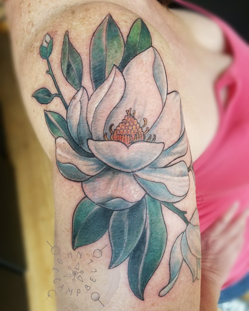 Color Tattoo of a Magnolia Blossom on the Shoulder done at Sacred Mandala Studio by Tattoo Artist John Campbell in Durham, NC. 