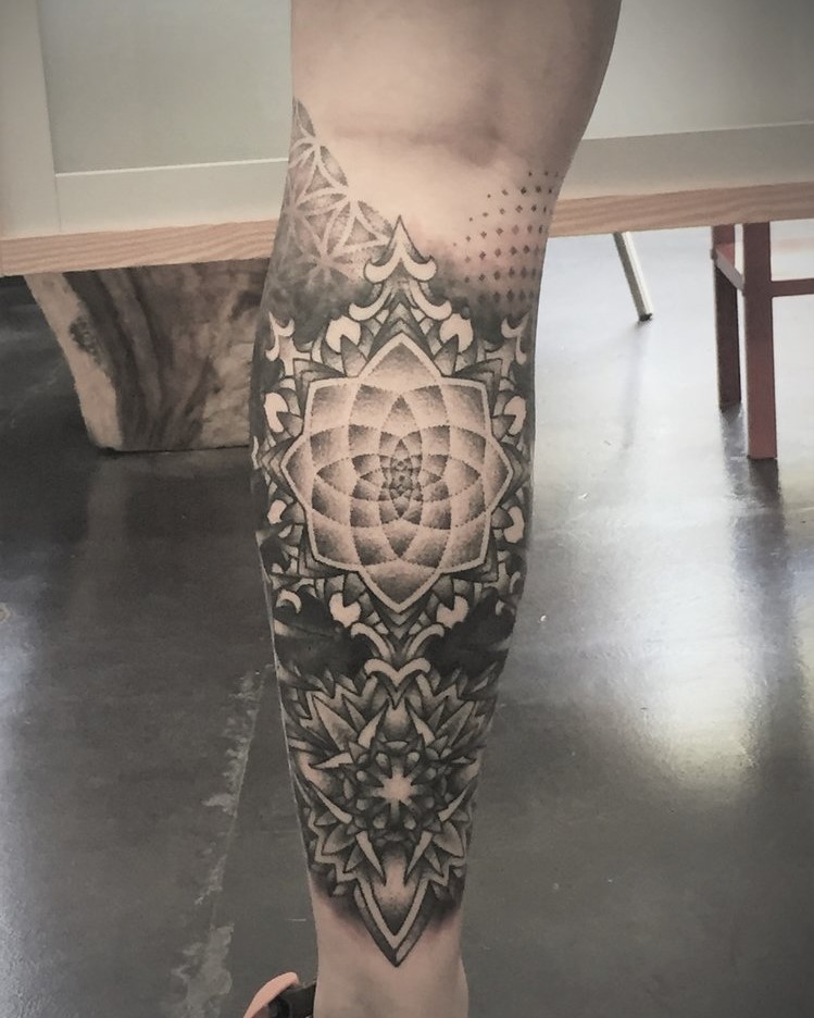 Tattoo Artist Alan Lott, available at Sacred Mandala Studio in Durham, NC, created this custom Lower Leg Partial Sleeve Tattoo of a Skulls Head Mandala in Black and Grey.