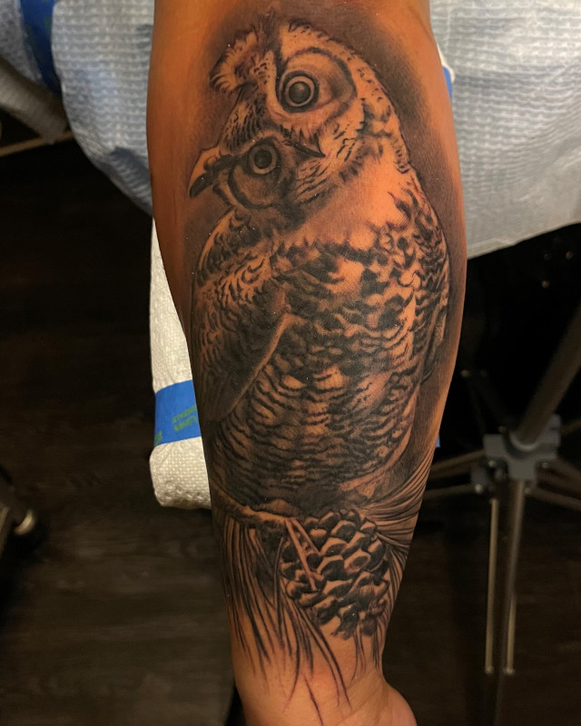 Black and grey owl with its head tilted tattoo  by Shaine Smith of Sacred Mandala Studio.