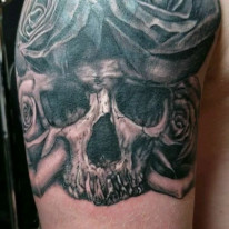 Black and grey skull tattoo created by tattoo artist Ray Durham.