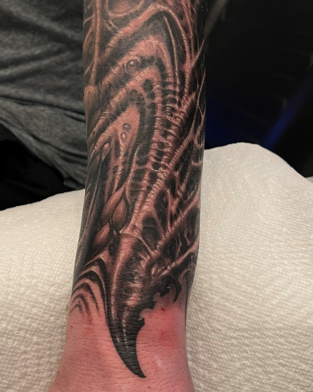 Black and grey super detailed dragon wing forearm tattoo by Shaine Smith of Sacred Mandala Studio.