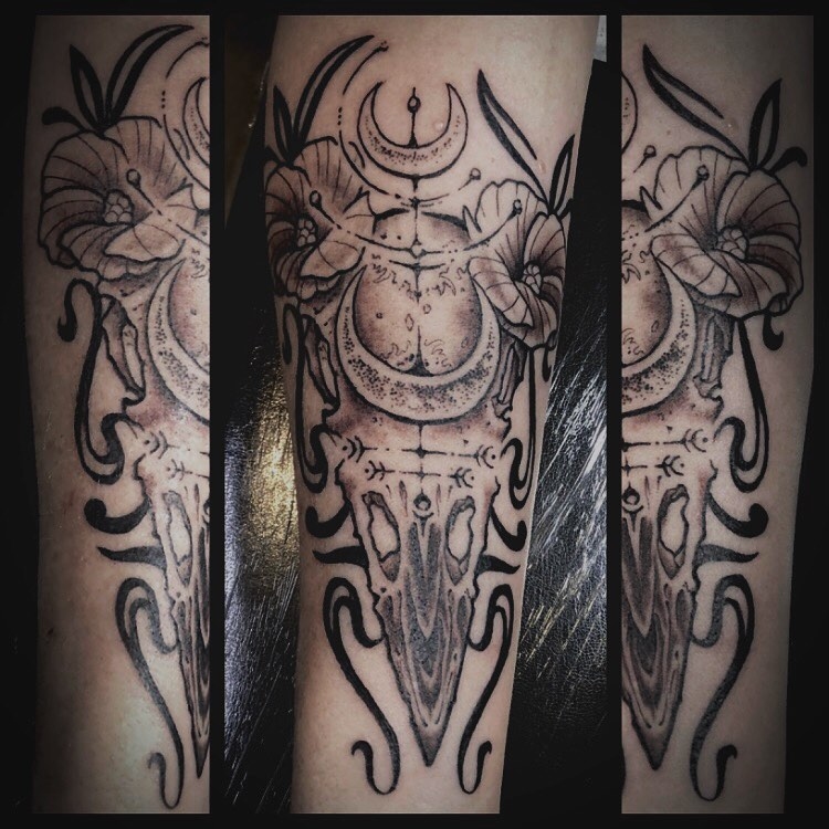 Black and grey fine line animal skull with flowers. Book a custom tattoo with Chris at Sacred Mandala Studio - Durham, NC.