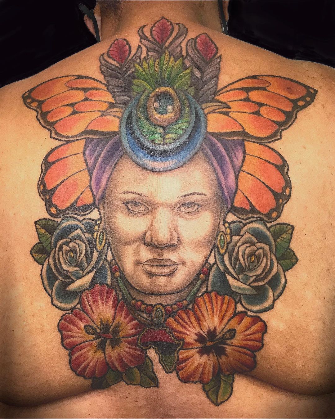 Colorful back cover-up portrait with flowers. Book a custom tattoo with Chris at Sacred Mandala Studio - Durham, NC.