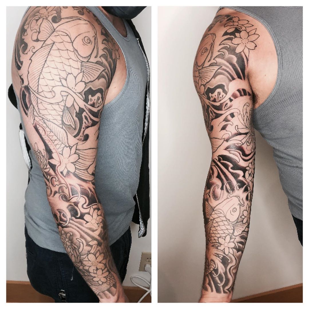 Full black and white sleeve with koi carp. Book a custom tattoo with Chris at Sacred Mandala Studio - Durham, NC.
