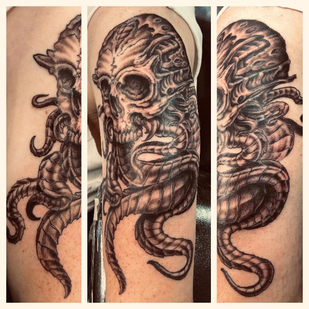 Lovecraftian skull in black and white with unknowably horrifying tentacles. Book a custom tattoo with Chris at Sacred Mandala Studio - Durham, NC.