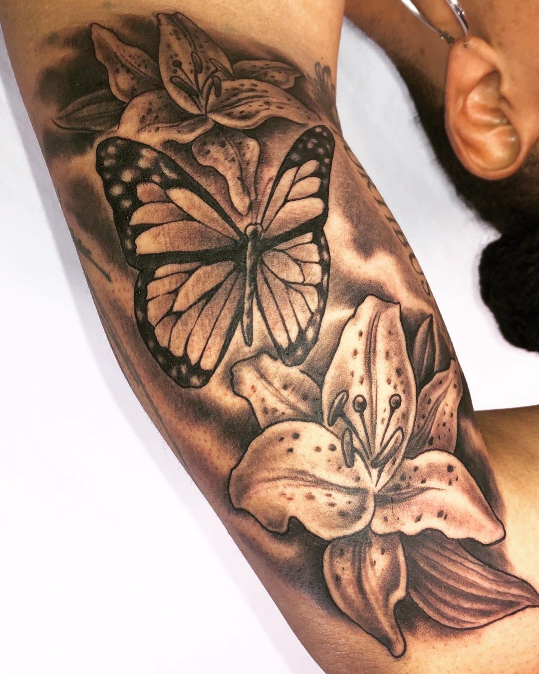 Black and white butterfly and flowers tattoo. Book a custom tattoo with Chris at Sacred Mandala Studio - Durham, NC.