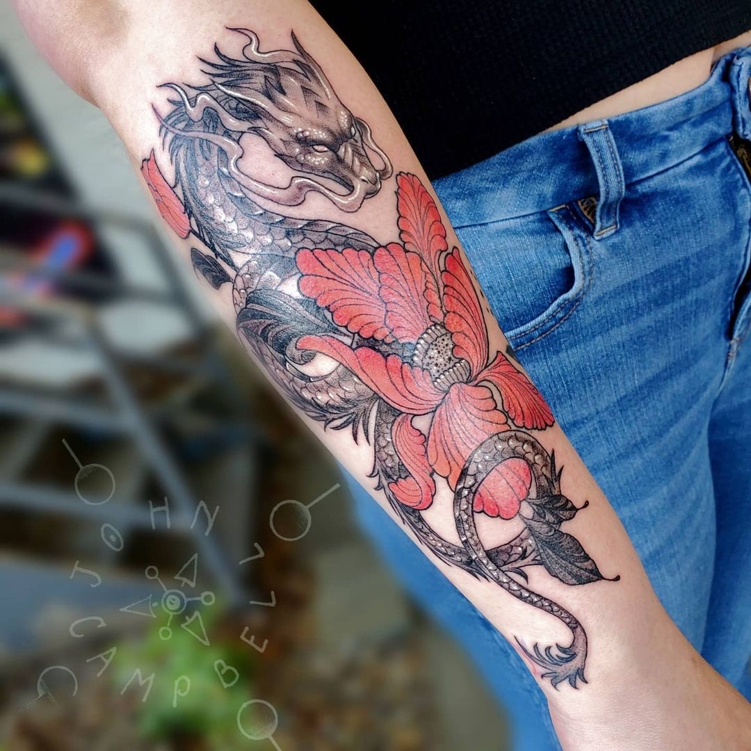 Fine line black and grey dragon tattoo with red flower. Book a custom tattoo with John at Sacred Mandala Studio - Durham, NC.