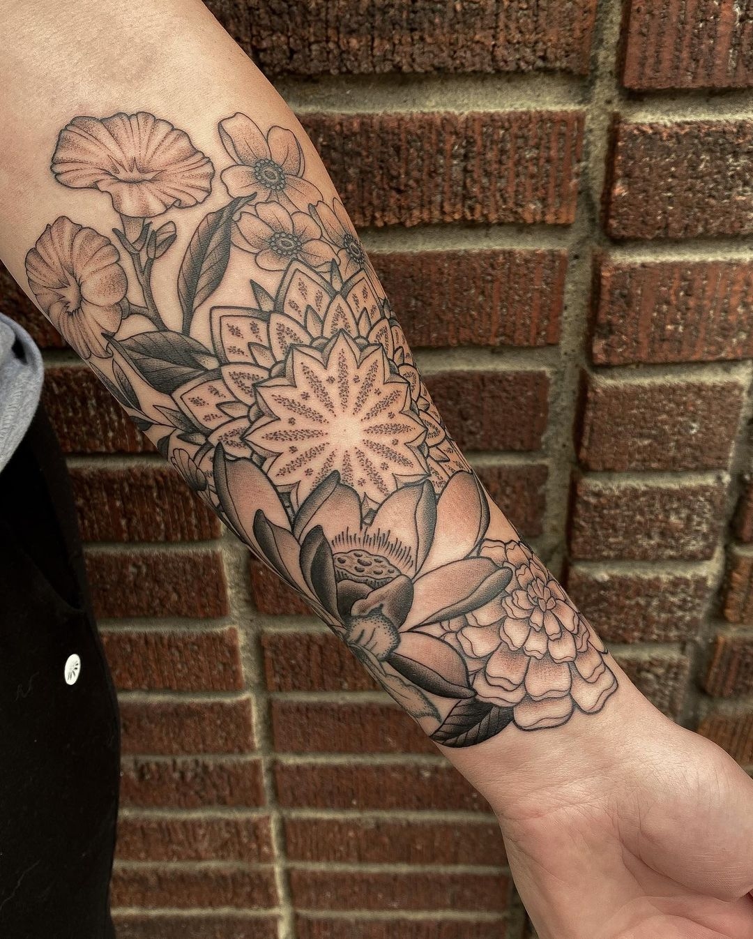 Fine line black and grey mandala tattoo surrounded by lotus flower, chrysanthemum, anemone and morning glory flowers created by tattoo artist Alan Lot of Sacred Mandala Studio in Durham, NC.