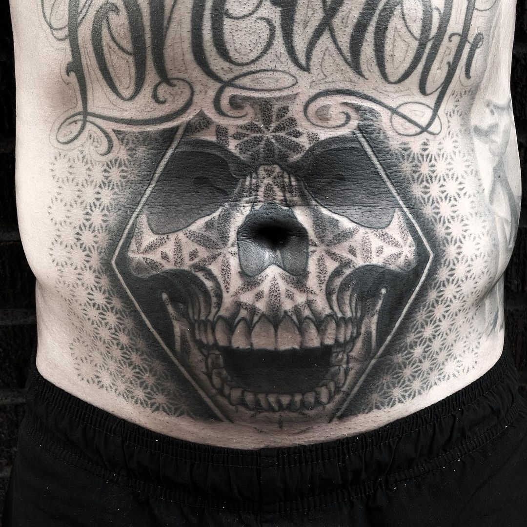 Skull stomach tattoo of a skull with black and grey mandala dot work by tattoo artist Alan Lott at Sacred Mandala Studio in Durham, NC
