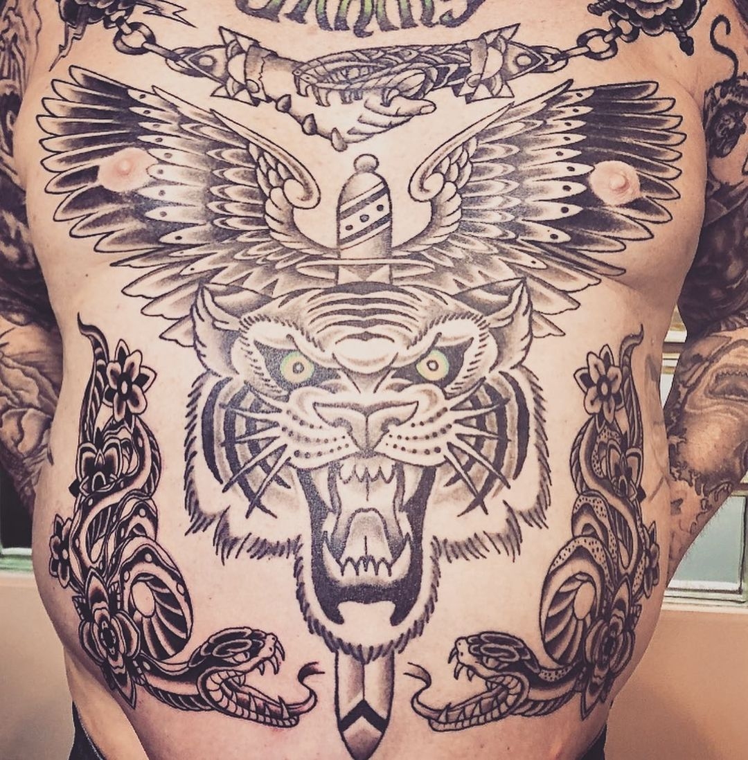 Full chest tattoo of a tiger with wings and serpents. Book a custom tattoo with Chris at Sacred Mandala Studio - Durham, NC.